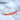 A clear and red rhinestone bikini competition bracelet with a crisscross design, displayed on a white surface.