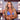 An NPC Bikini and Figure Competition female bodybuilder is wearing a silver bikini jewelry bracelet adorned with clear oval and round cut cubic zirconia rhinestones.
