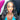 An NPC bikini and figure competition female bodybuilder wearing a pair of clear silver rhinestone drop bikini jewelry earrings.