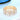 A gold-colored bubble-shaped stretch bikini jewelry rhinestone bracelet with clear diamante accents, displayed on a blue textured background.