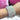 A stretchable bikini jewelry bracelet with multicolored rhinestones displayed on a person's wrist.