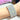 A stretchable bikini jewelry bracelet with silver-colored rhinestones on a person's wrist.