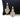 A pair of gold finish floral chandelier bikini jewelry earrings adorned with multicolored rhinestones, displayed against a black cushion.