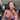 A pair of silver-colored rhinestone dangle bikini jewelry earrings displayed by an npc bikini fit model.