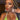 A pair of silver floral chandelier bikini jewelry earrings adorned with AB rhinestones, displayed by an npc bikini fit model.