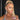 A pair of silver drop bikini jewelry earrings adorned with clear and AB marquise rhinestones, displayed by an npc bikini fit model.