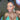 A pair of clear silver teardrop rhinestone bikini jewelry earrings displayed by an npc bikini fit model.