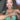A bikini and figure competition female bodybuilder wears a silver stretch bubble rhinestone bikini jewelry bracelet with alternating bands of rhinestones and a mix of colorful and clear bubbles.
