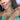 A bikini and figure competition female bodybuilder wears a silver stretch bubble rhinestone bikini jewelry bracelet with alternating bands of rhinestones and a mix of colorful and clear bubbles.