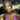 A pair of clear ab pave rhinestone dangle bikini jewelry earrings displayed by an npc bikini fit model.