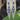 Video showing Blue gemstone bikini competition earrings on a hand with a green grass background