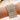 A stretchable bikini jewelry bracelet featuring clear rhinestone crystals set in a gold-tone metal