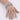 A clear silver pave rhinestone stretch bikini jewelry bracelet displayed on a mannequin hand.