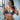 A pair of clear silver chandelier rhinestone bikini jewelry earrings displayed by a bikini and figure competition female bodybuilder.