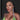 A clear silver rhinestone dangle bikini jewelry earrings displayed by a bikini and figure competition female bodybuilder.