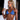 A pair of clear silver marquise statement rhinestone bikini jewelry earrings displayed by an npc bikini fit model. The earrings are adorned with multiple rhinestones creating a sparkling effect.