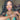 A bikini and figure competition female bodybuilder wears a silver stretch bubble rhinestone bikini jewelry bracelet with alternating bands of rhinestones and a mix of colorful and clear bubbles.