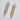A pair of gold rhinestone dangle bikini jewelry earrings with clear and ab cluster stones, displayed on a white fabric surface.
